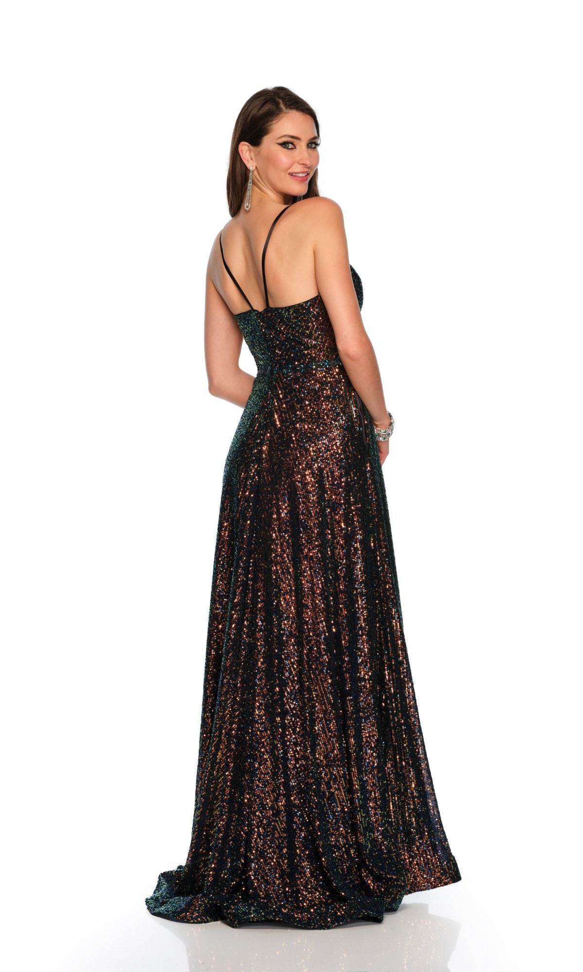 A woman in the Dave & Johnny 11278 long black sequin prom dress with thin straps stands facing slightly away, looking over her shoulder against a white background.